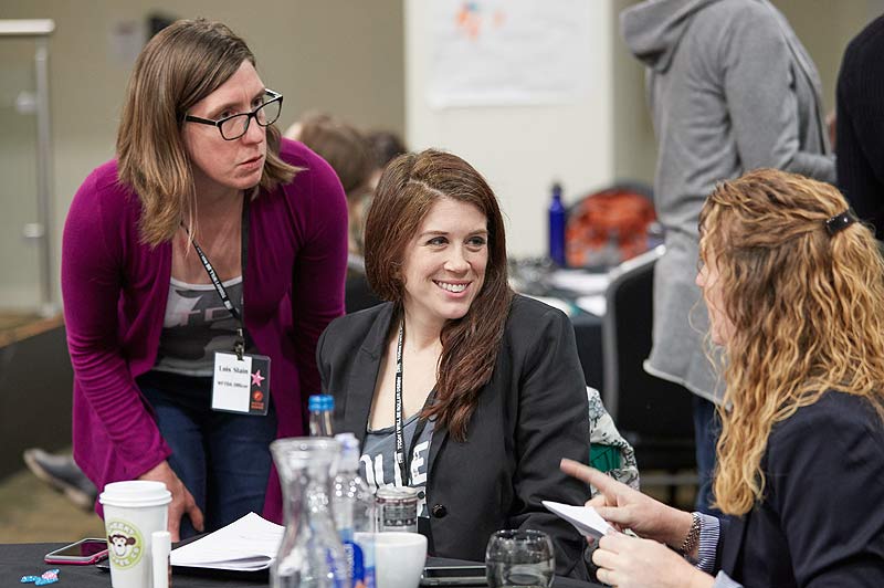 The organisers of the WFTDA World Summit discuss ideas between breakout sessions