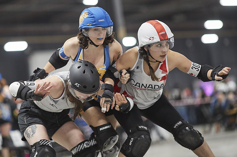 Canadian players block Greece's jammer